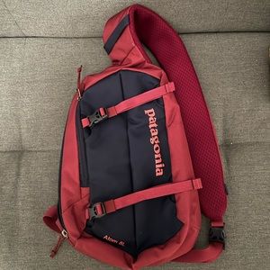 Patagonia navy blue and pink Atom 8L sling bag